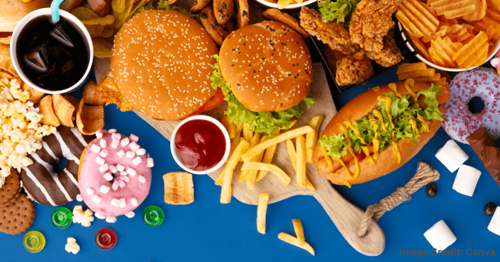 햄버거, 감자튀김, 핫도그, 도넛 등 다양한 패스트푸드가 놓여 있는 테이블 (Table Full of Burgers, Fries, Hot Dog, and Donuts)